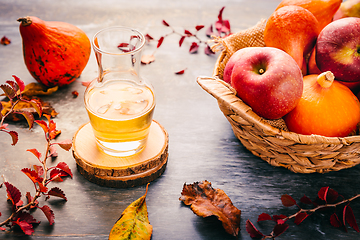 Image showing Autumn composition with pumpkins, autumn leaves, red apples and apple cider