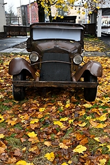 Image showing old vintage car in autumn with autumn leaves