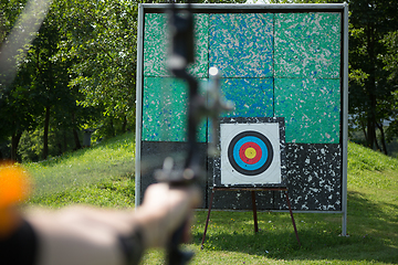 Image showing Archer holds his bow aiming at a target