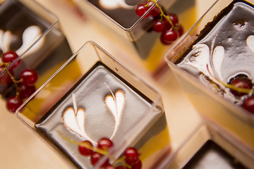 Image showing Layered dessert with fruits, nuts and cream cheese in glass jar