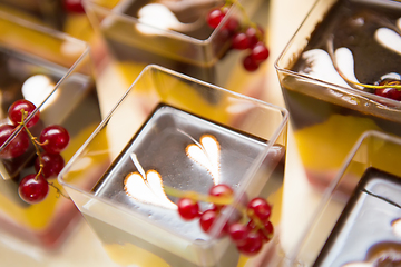 Image showing Layered dessert with fruits, nuts and cream cheese in glass jar