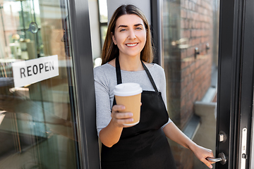 Image showing happy woman with coffee and reopen banner on door