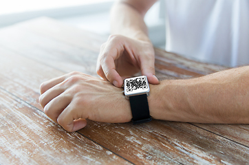 Image showing male hands with qr code on smart watch