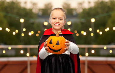 Image showing girl in halloween costume of dracula with pumpkin