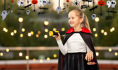 Image showing girl in halloween costume of dracula with candies