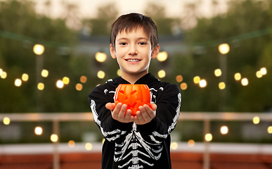 Image showing boy in halloween costume with jack-o-lantern