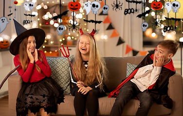 Image showing kids in halloween costumes playing at home