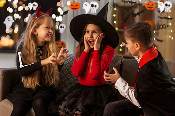 Image showing kids in halloween costumes playing at home