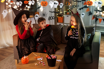 Image showing kids in halloween costumes playing at home