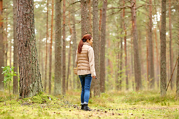 Image showing asian woman picking mushrooms in autumn forest