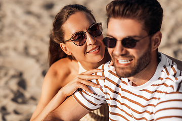 Image showing happy couple chilling on summer beach