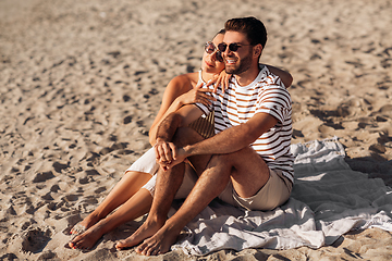 Image showing happy couple chilling on summer beach