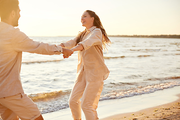 Image showing happy couple hugging on summer beach