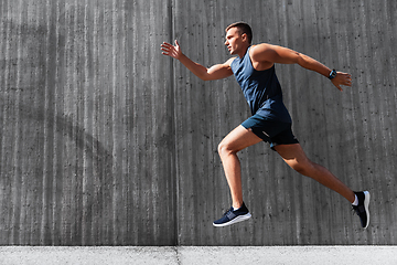 Image showing young man running outdoors