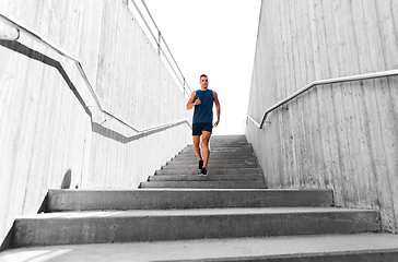 Image showing young man running downstairs