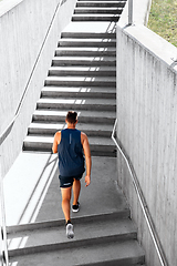 Image showing young man running upstairs