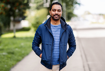 Image showing happy smiling indian man in jacket on city street