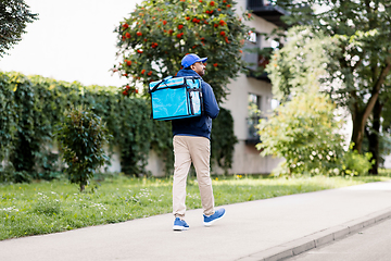 Image showing indian delivery man with bag walking in city