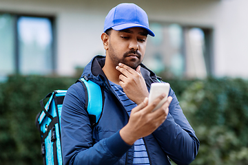 Image showing indian delivery man with bag and phone