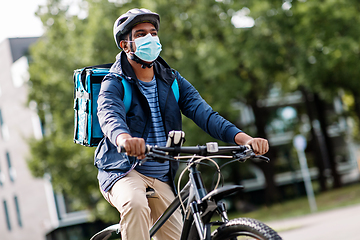 Image showing delivery man in mask with smatphone riding bicycle