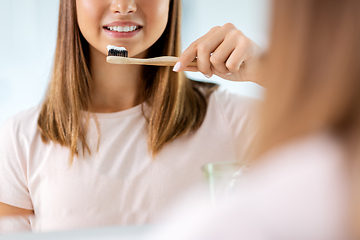 Image showing teenage girl with toothbrush brushing teeth