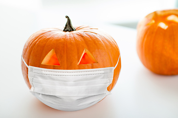 Image showing carved pumpkin or jack-o-lantern in medical mask