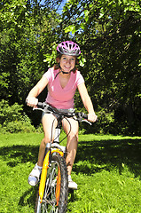 Image showing Teenage girl on a bicycle