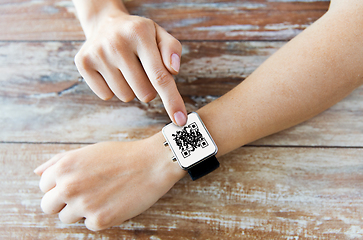 Image showing woman's hands with qr code on smart watch