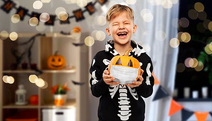 Image showing happy boy with pumpkin in mask on halloween