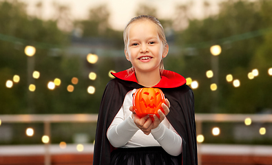 Image showing girl in halloween costume of dracula with pumpkin