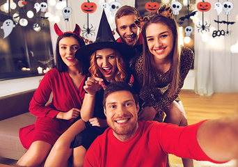 Image showing happy friends in halloween costumes taking selfie