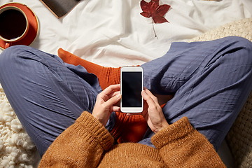 Image showing woman with smartphone at home in autumn