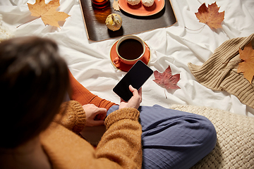 Image showing woman with smartphone at home in autumn