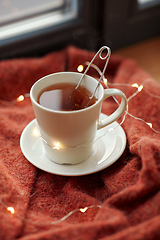 Image showing cup of tea and garland lights on window sill