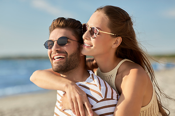 Image showing happy couple hugging on summer beach