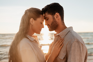 Image showing happy couple with closed eyes on summer beach