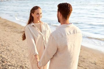 Image showing happy couple holding hands on summer beach