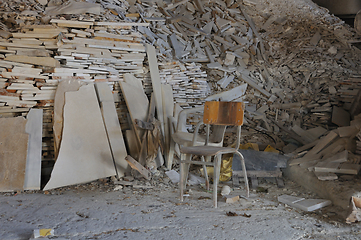 Image showing dusty chair and pile of broken marble