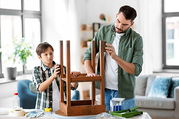 Image showing father and son sanding old table with sponge