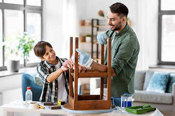 Image showing father and son cleaning old table with tissue