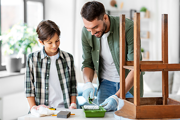 Image showing father and son painting old table at home