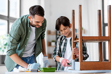 Image showing father and son painting old table in grey color