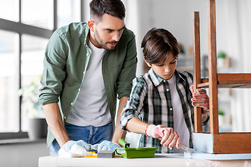 Image showing father and son painting old table in grey color