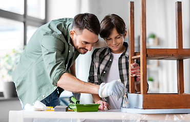 Image showing father and son painting old table in grey color