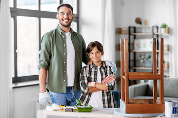 Image showing father and son restoring old table at home