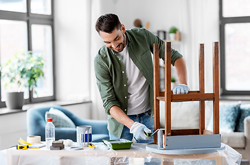 Image showing man painting old table in grey color at home