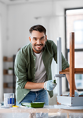 Image showing man painting old table in grey color at home