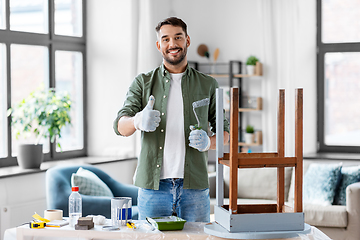 Image showing man painting old table in grey color at home