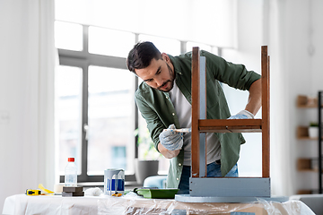 Image showing man painting old wooden table in grey color