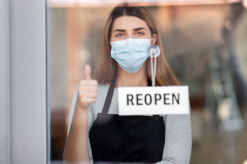 Image showing woman in mask with reopen banner showing thumbs up